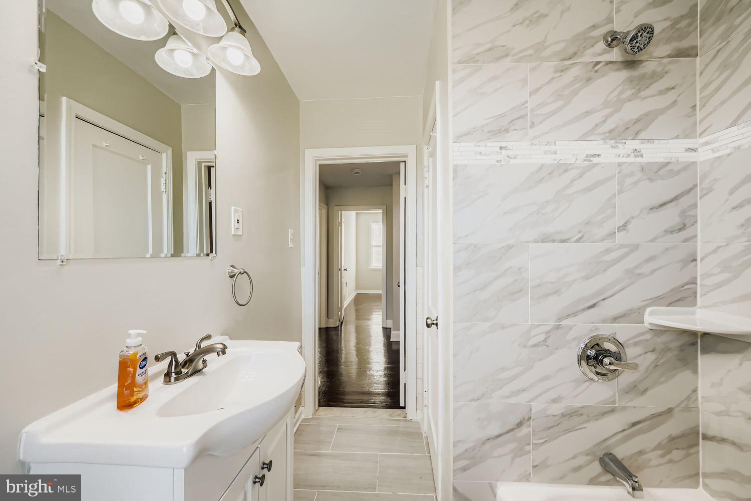 3711 Ina Avenue Baltimore, MD 21206 - Photo 17 of 29 a bathroom with a sink a toilet and shower