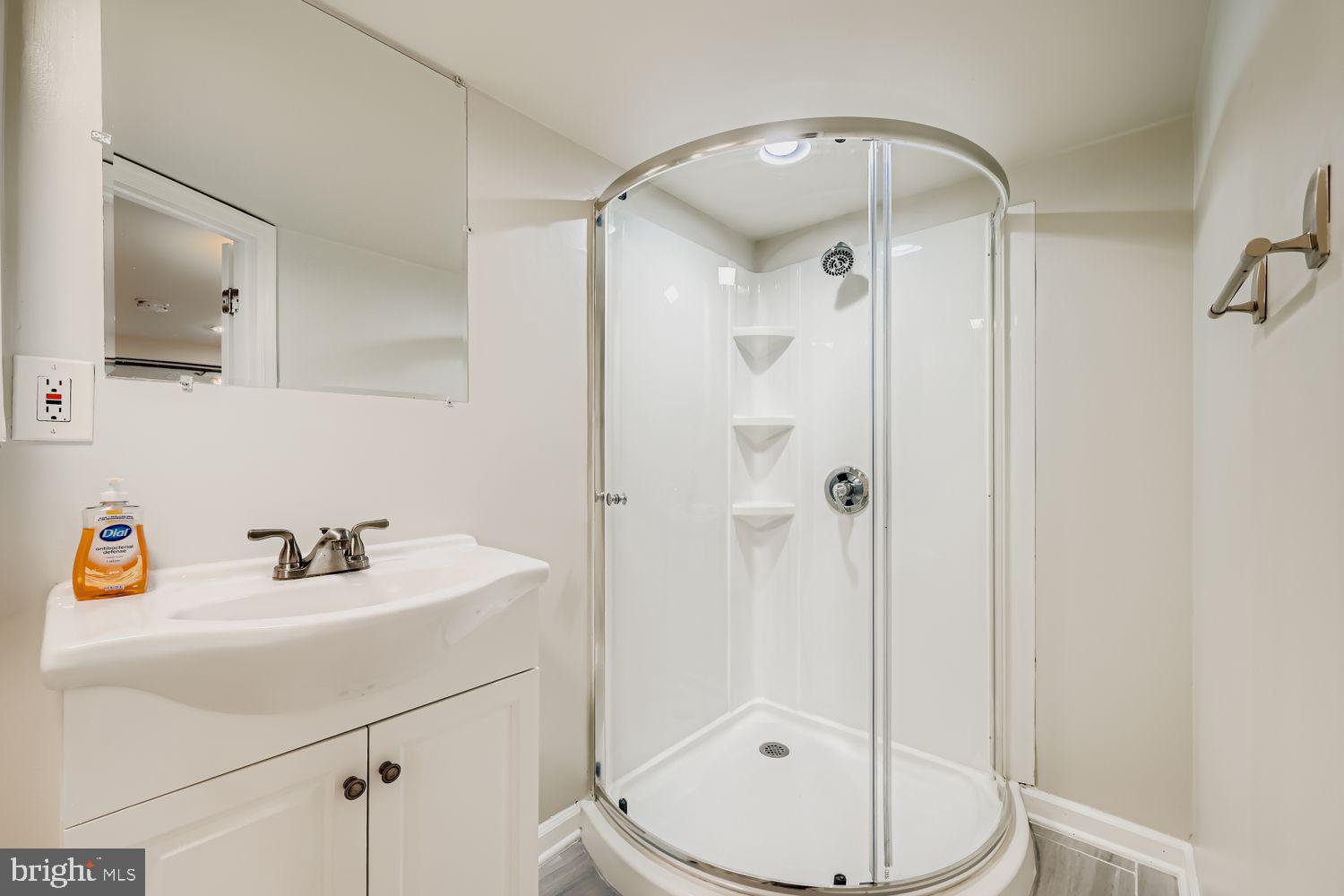 3711 Ina Avenue Baltimore, MD 21206 - Photo 22 of 29 a bathroom with a sink a toilet and shower