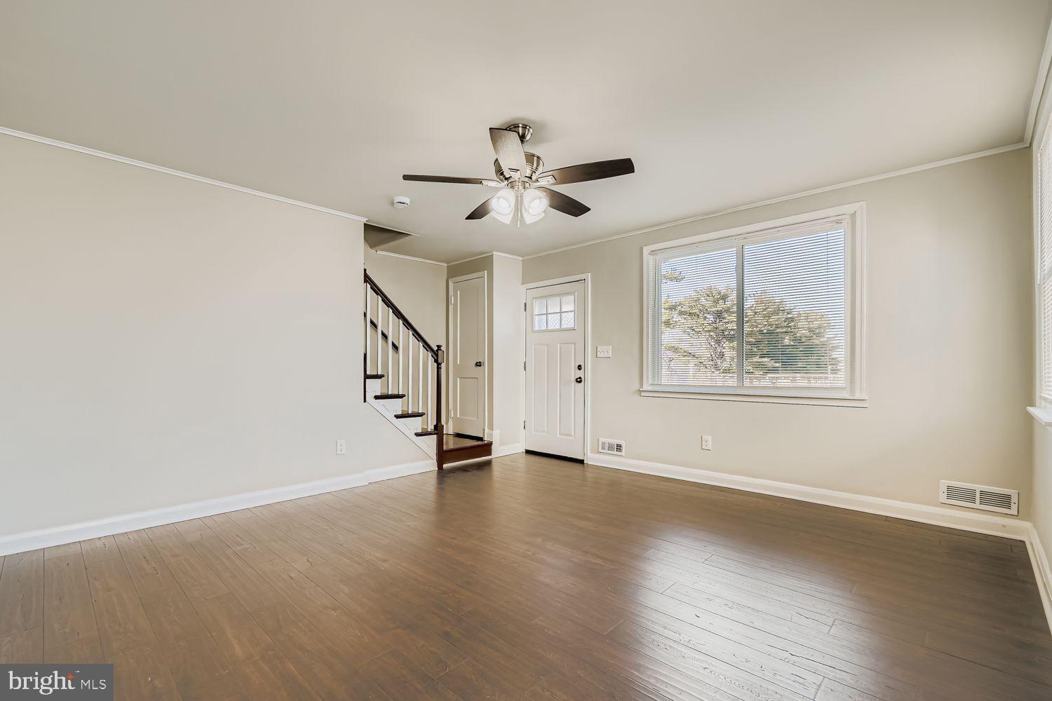 3711 Ina Avenue Baltimore, MD 21206 - Photo 6 of 29 a view of an empty room with a window and a ceiling fan