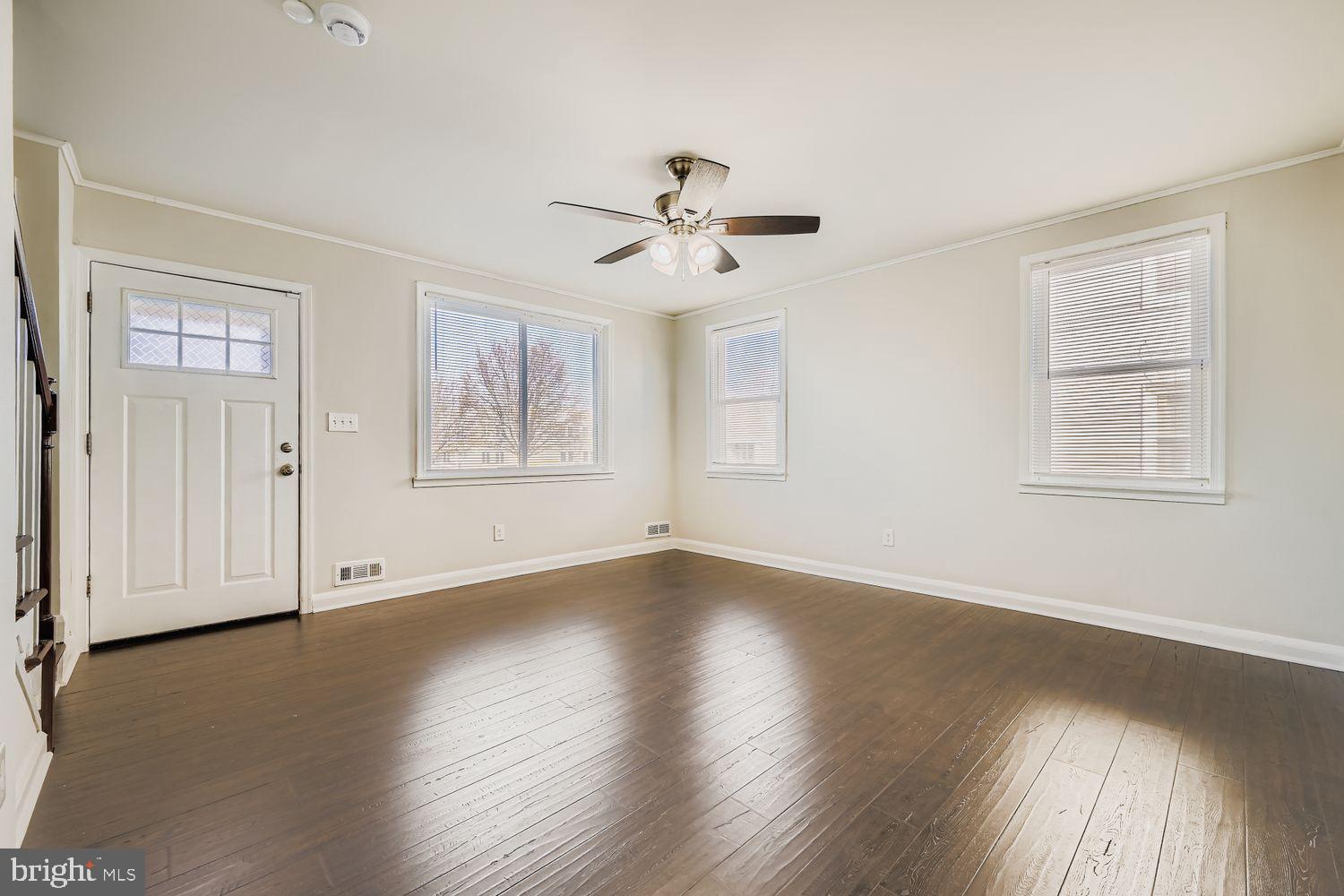 3711 Ina Avenue Baltimore, MD 21206 - Photo 8 of 29 a view of an empty room with wooden floor and a window