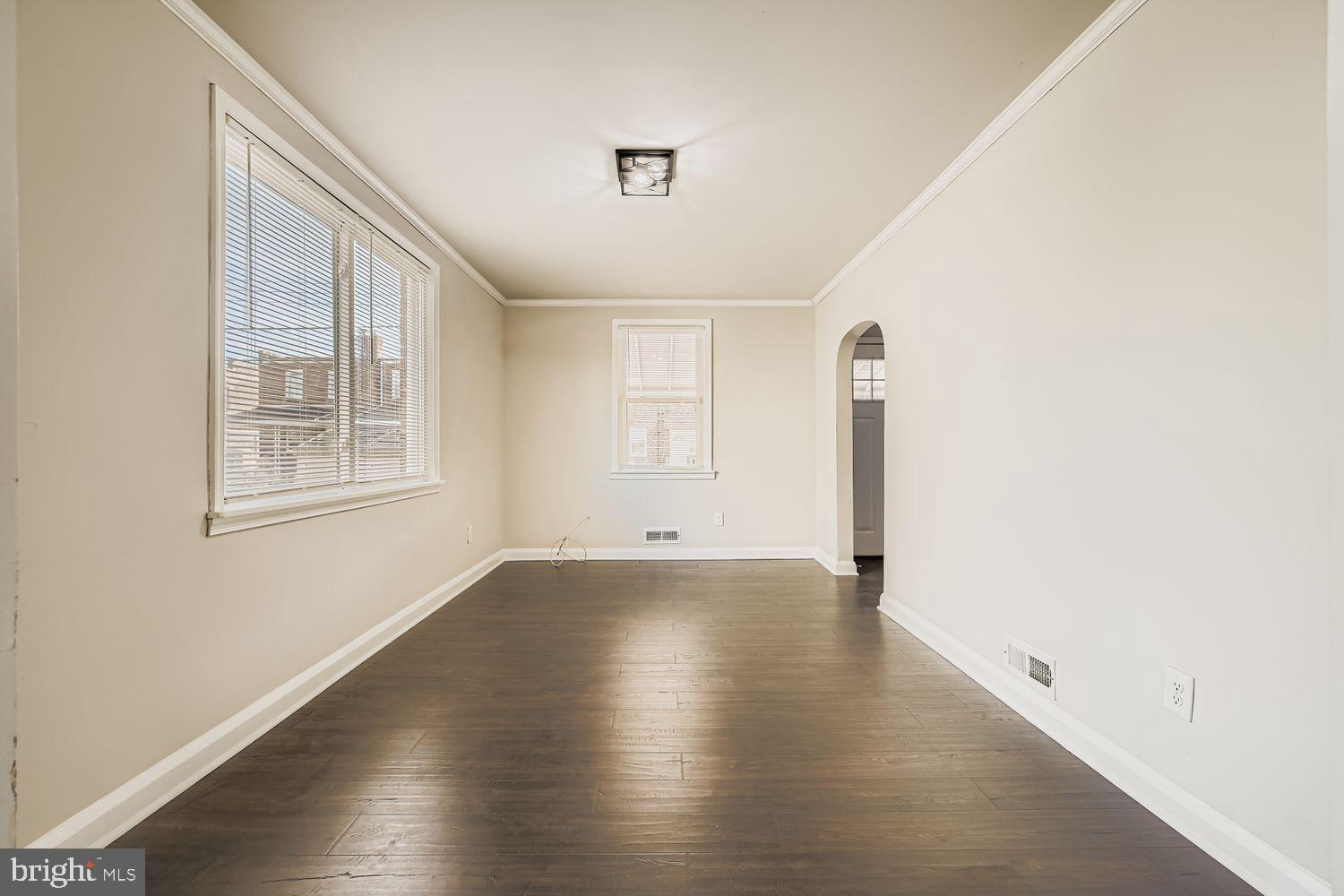 3711 Ina Avenue Baltimore, MD 21206 - Photo 9 of 29 a view of an empty room with wooden floor and a window
