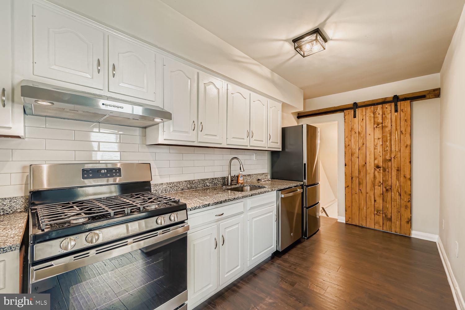 3711 Ina Avenue Baltimore, MD 21206 - Photo 10 of 29 a kitchen with stainless steel appliances granite countertop a stove and a refrigerator