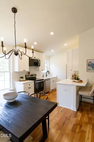 a view of a dining room with furniture window and wooden floor