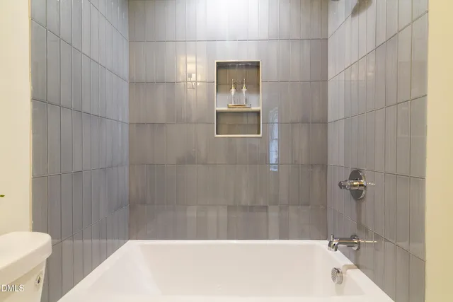 a bathroom with a sink a toilet and bathtub