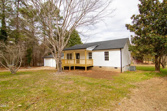 a bath tub sitting next to a white toilet and a shower