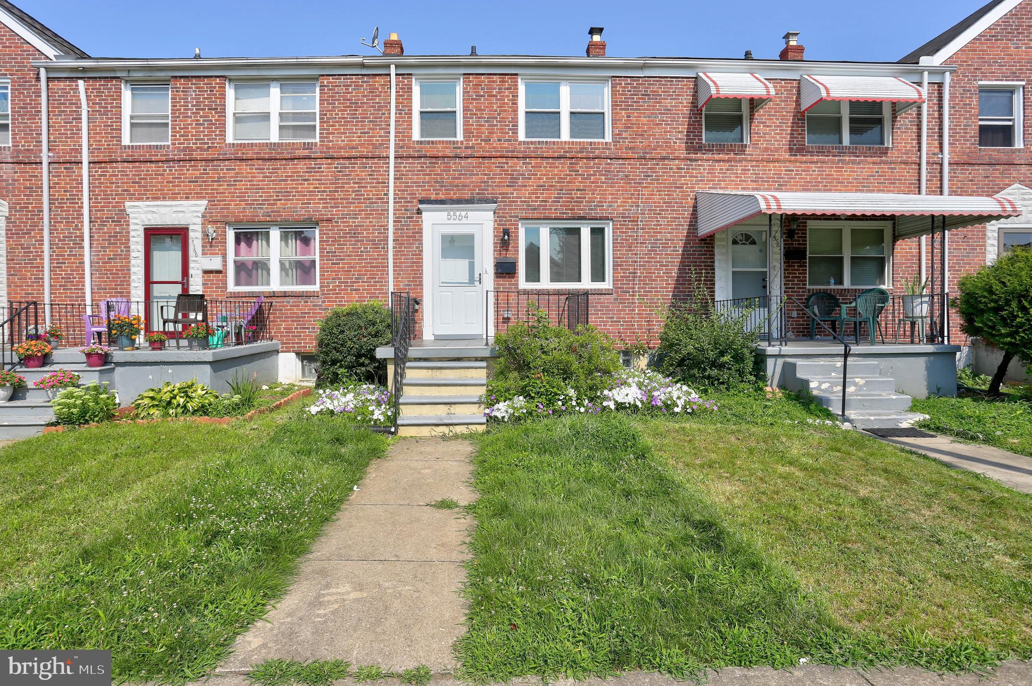 5564 Channing Road Baltimore, MD 21229 - Photo 1 of 32 front view of a brick house with a yard