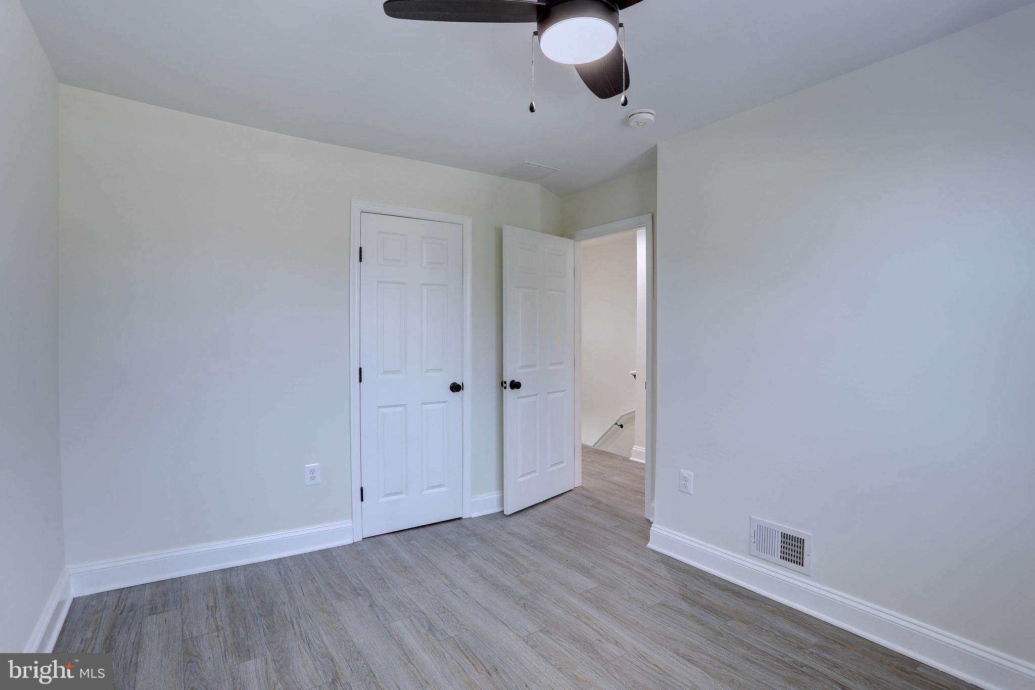 5564 Channing Road Baltimore, MD 21229 - Photo 17 of 32 a view of an empty room and wooden floor