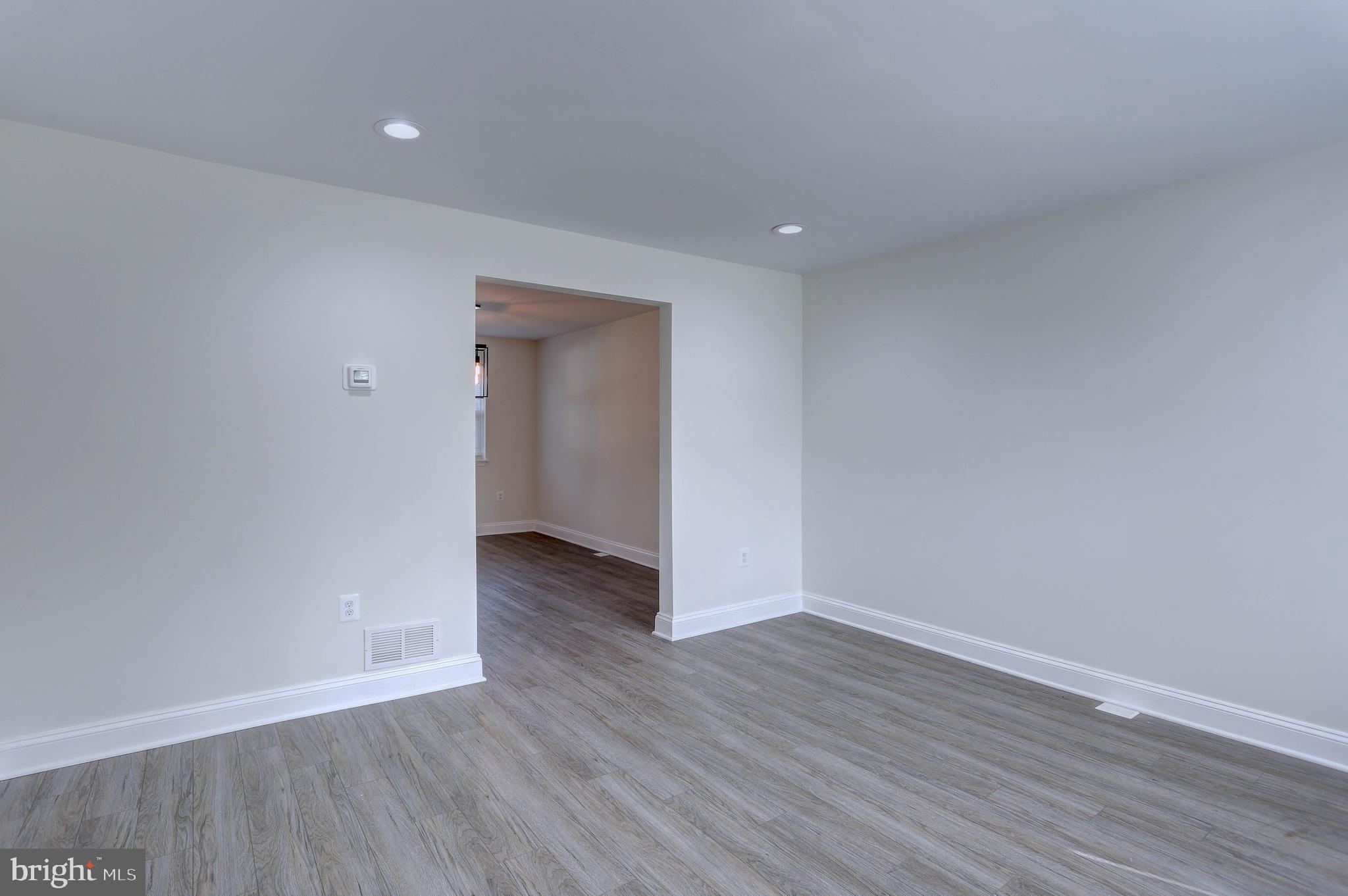 5564 Channing Road Baltimore, MD 21229 - Photo 4 of 32 a view of an empty room with wooden floor and closet