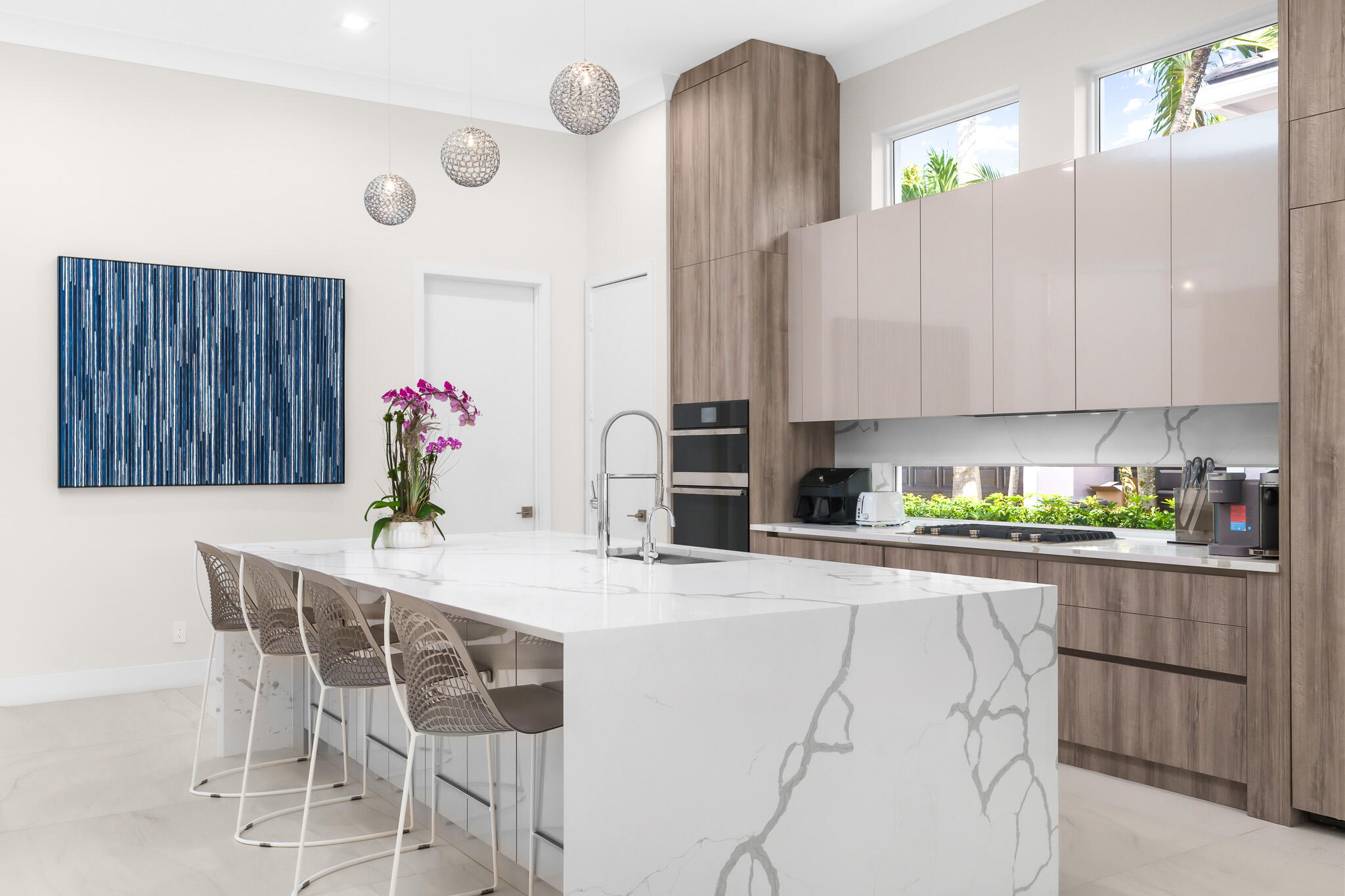 7952 Trieste Place Delray Beach, FL 33446 - Photo 5 of 59 a kitchen with stainless steel appliances kitchen island granite countertop a table chairs in it and wooden floors