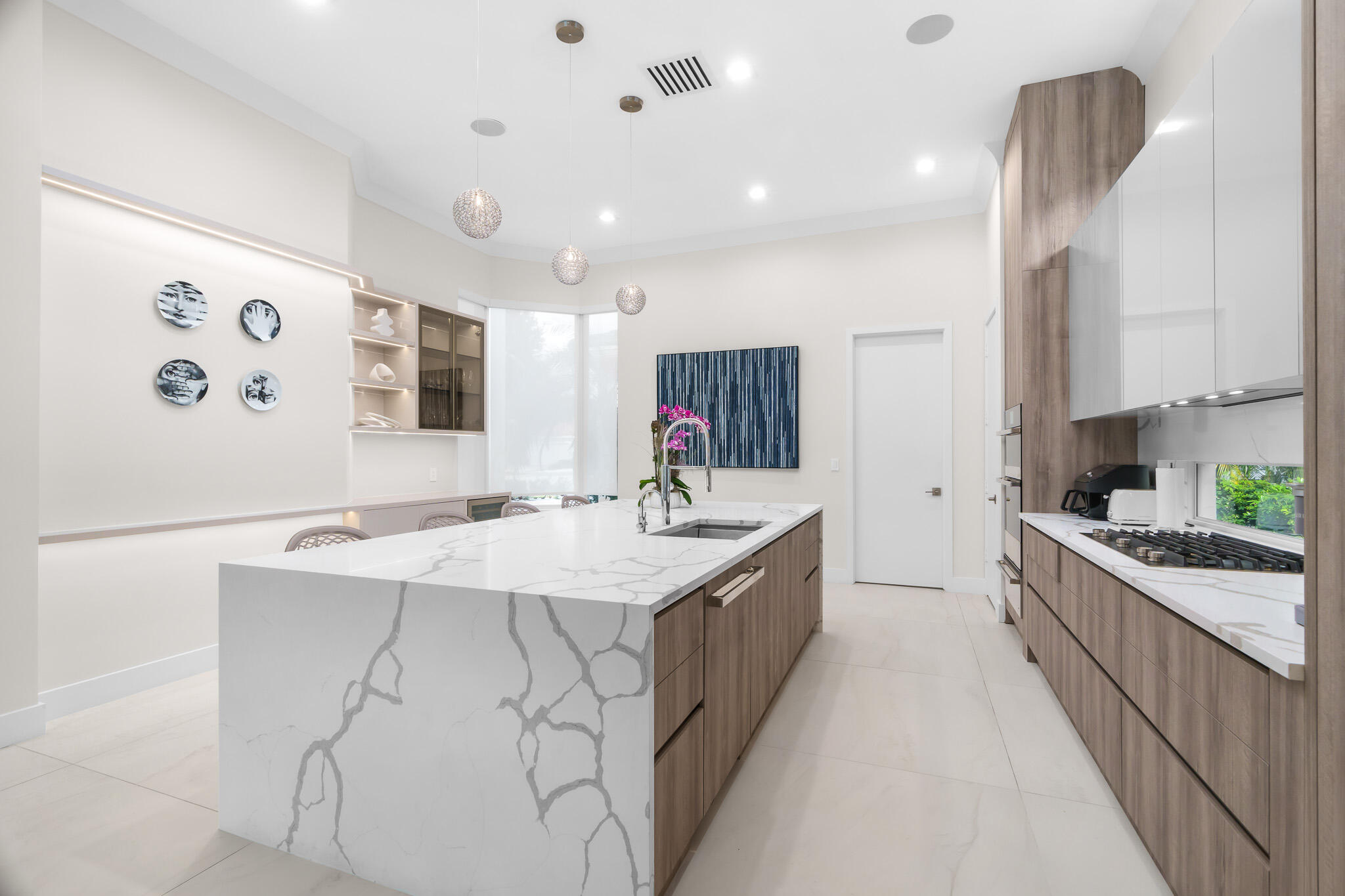 7952 Trieste Place Delray Beach, FL 33446 - Photo 6 of 59 a large kitchen with kitchen island a sink stainless steel appliances and cabinets
