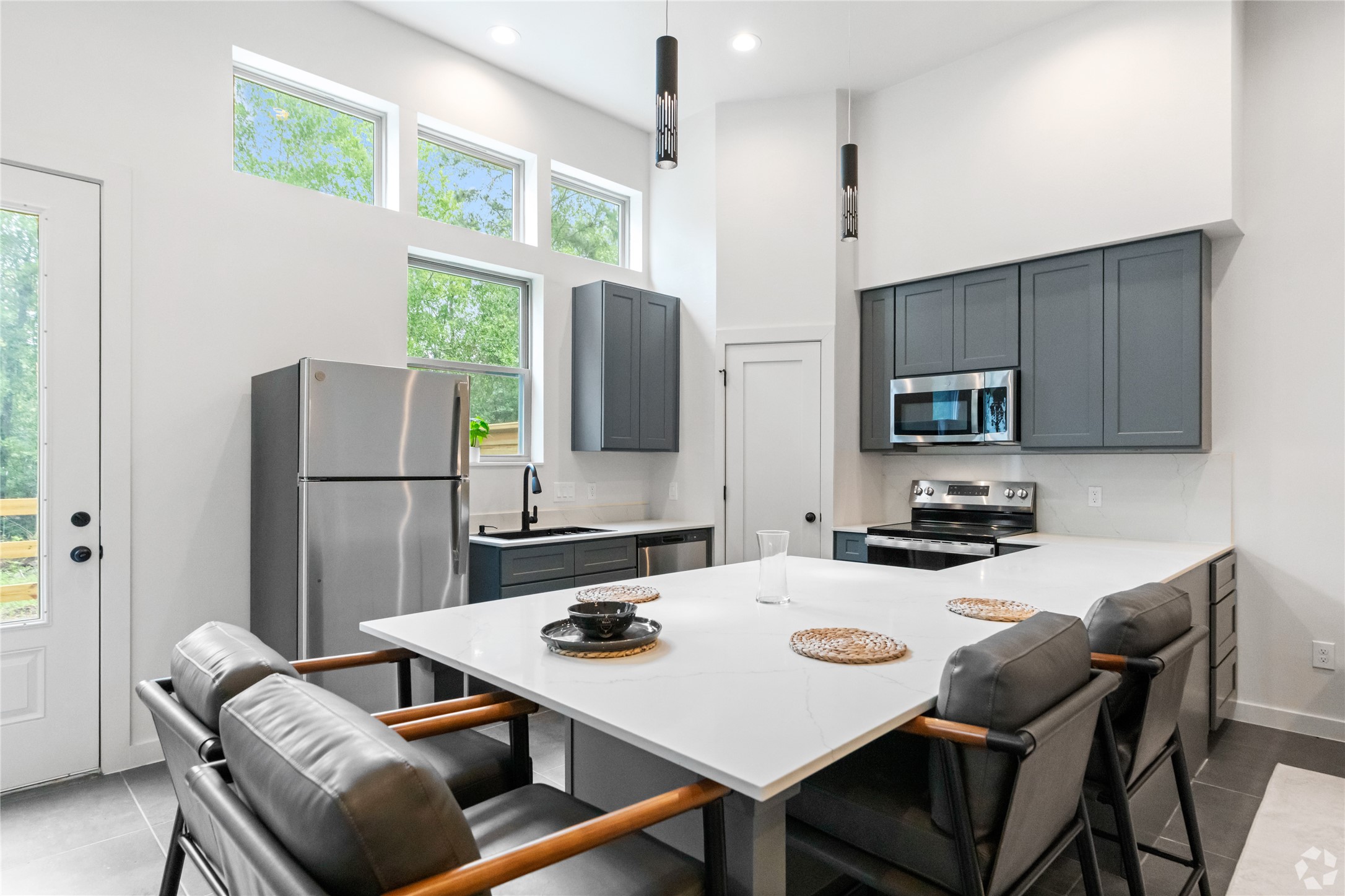 13106 Beauty Berry Ridge Lane Cypress, TX 77429 - Photo 6 of 24 a kitchen with stainless steel appliances granite countertop a stove a refrigerator a sink a dining table and chairs with wooden floor