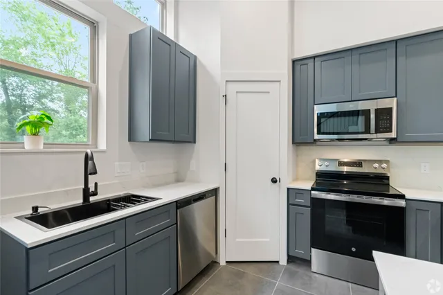 a kitchen with a sink and a stove top oven