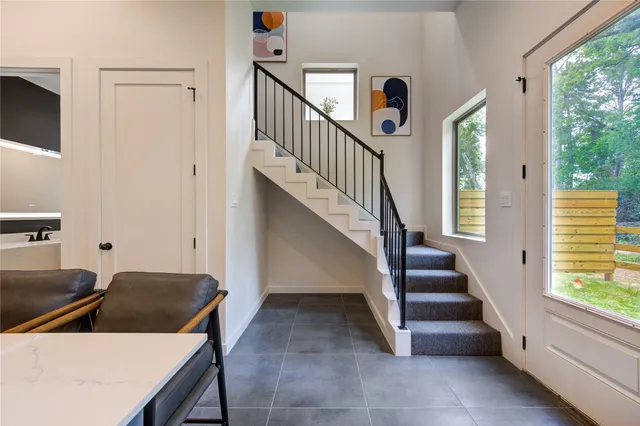 a view of a livingroom with wooden floor and staircase