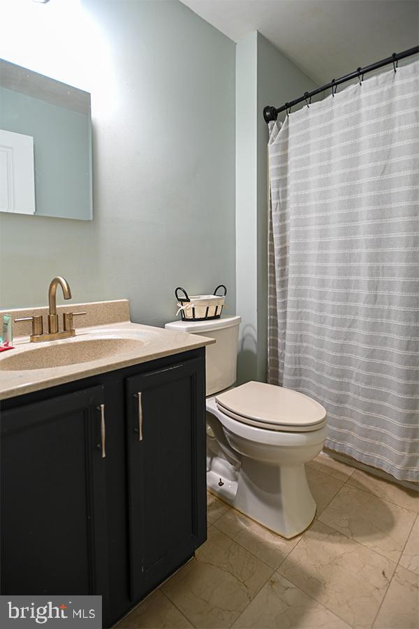 368 Almond Road Pittsgrove, NJ 08318 - Photo 17 of 40 a bathroom with a sink a toilet and shower curtain