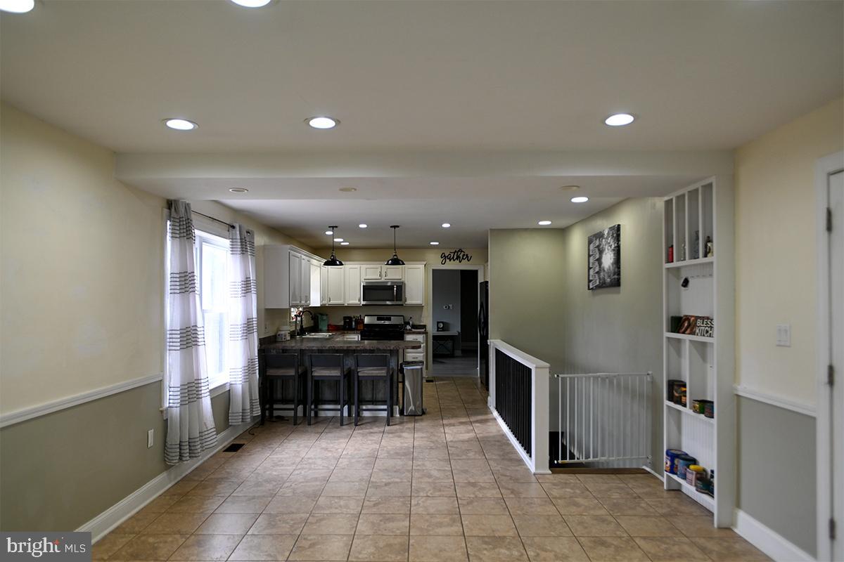 368 Almond Road Pittsgrove, NJ 08318 - Photo 18 of 40 a kitchen with stainless steel appliances kitchen island granite countertop a refrigerator and a sink