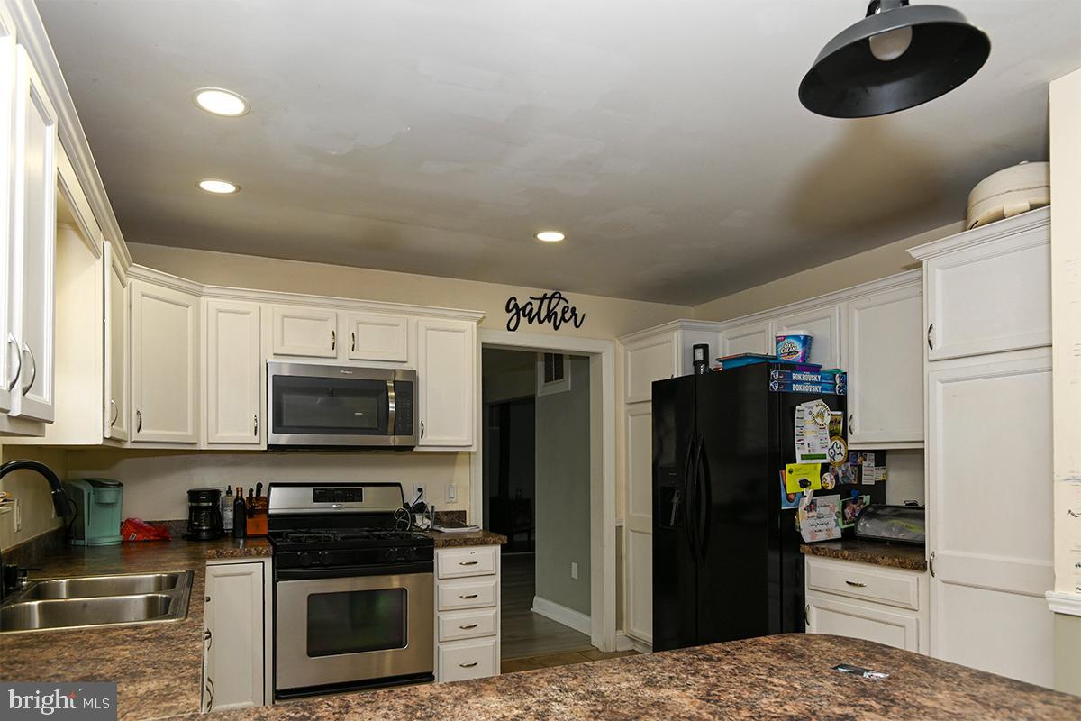 368 Almond Road Pittsgrove, NJ 08318 - Photo 19 of 40 a kitchen with stainless steel appliances kitchen island granite countertop a refrigerator oven a sink dishwasher and a stove with wooden floor