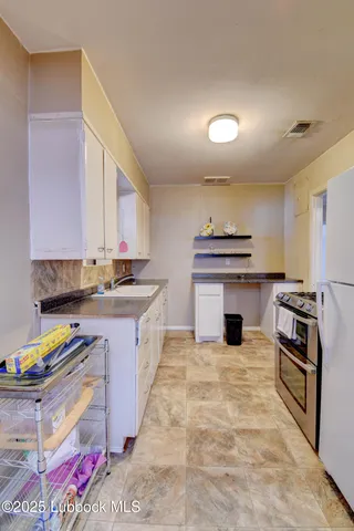 a kitchen that has a sink and a stove