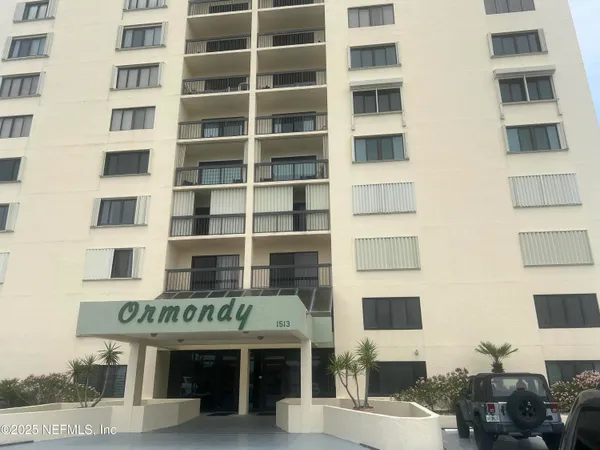 a front view of a building with parking space