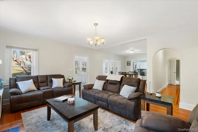 a living room with furniture a rug and a chandelier