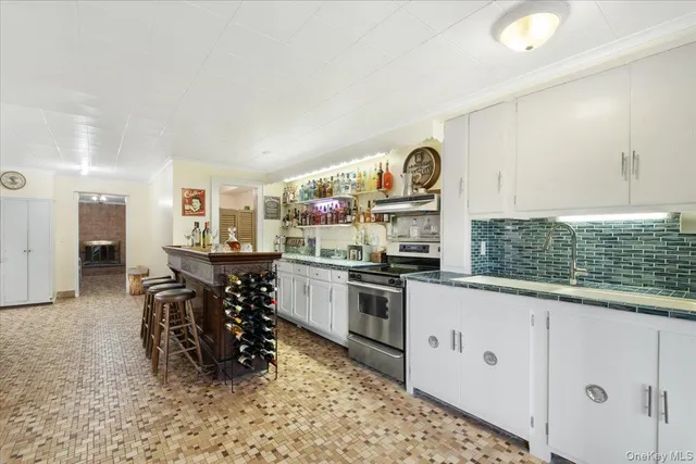 a kitchen with a sink and a stove top oven