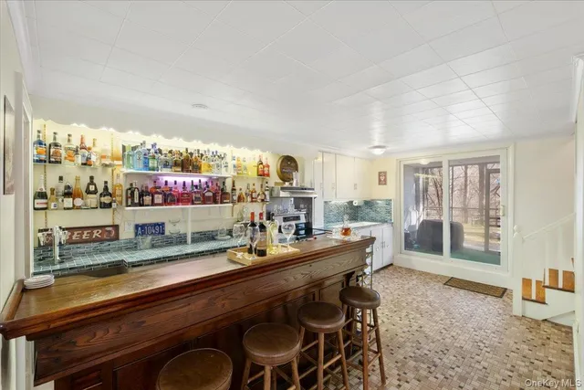 a room with stainless steel appliances kitchen island granite countertop a sink and cabinets