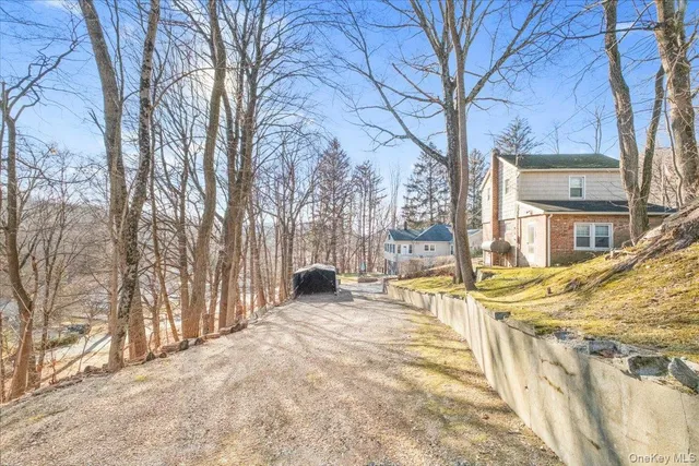 a backyard of house with a barbeque and trees
