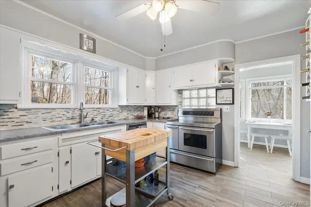 a kitchen with a stove a sink and a microwave