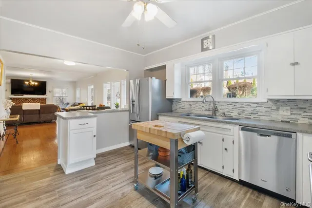 a kitchen with white cabinets and appliances