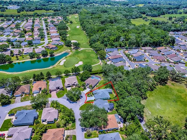 an aerial view of residential houses with outdoor space and river