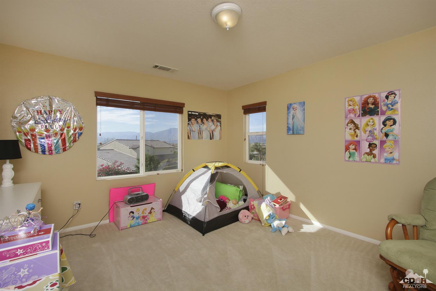 82785 Mount Riley Drive Indio, CA 92203 - Photo 26 of 35 a bedroom with a bed and a couch