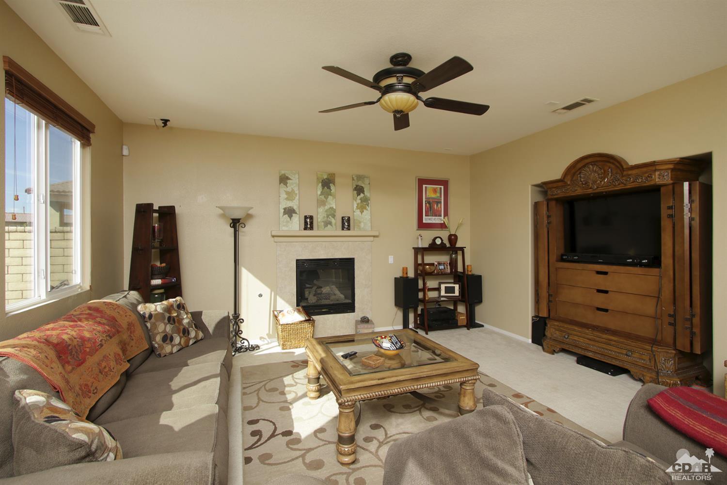 82785 Mount Riley Drive Indio, CA 92203 - Photo 3 of 35 a living room with furniture and a flat screen tv