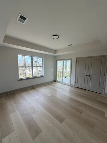 a bathroom with a sink a toilet a mirror and shower