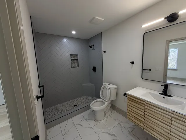 a bathroom with a toilet a sink and a mirror
