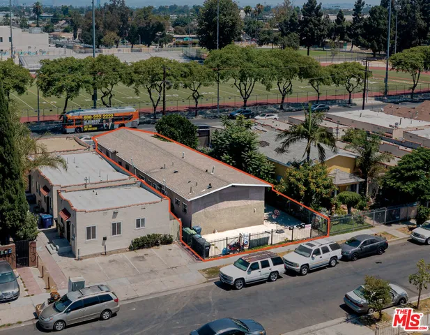 an aerial view of a house with car parked