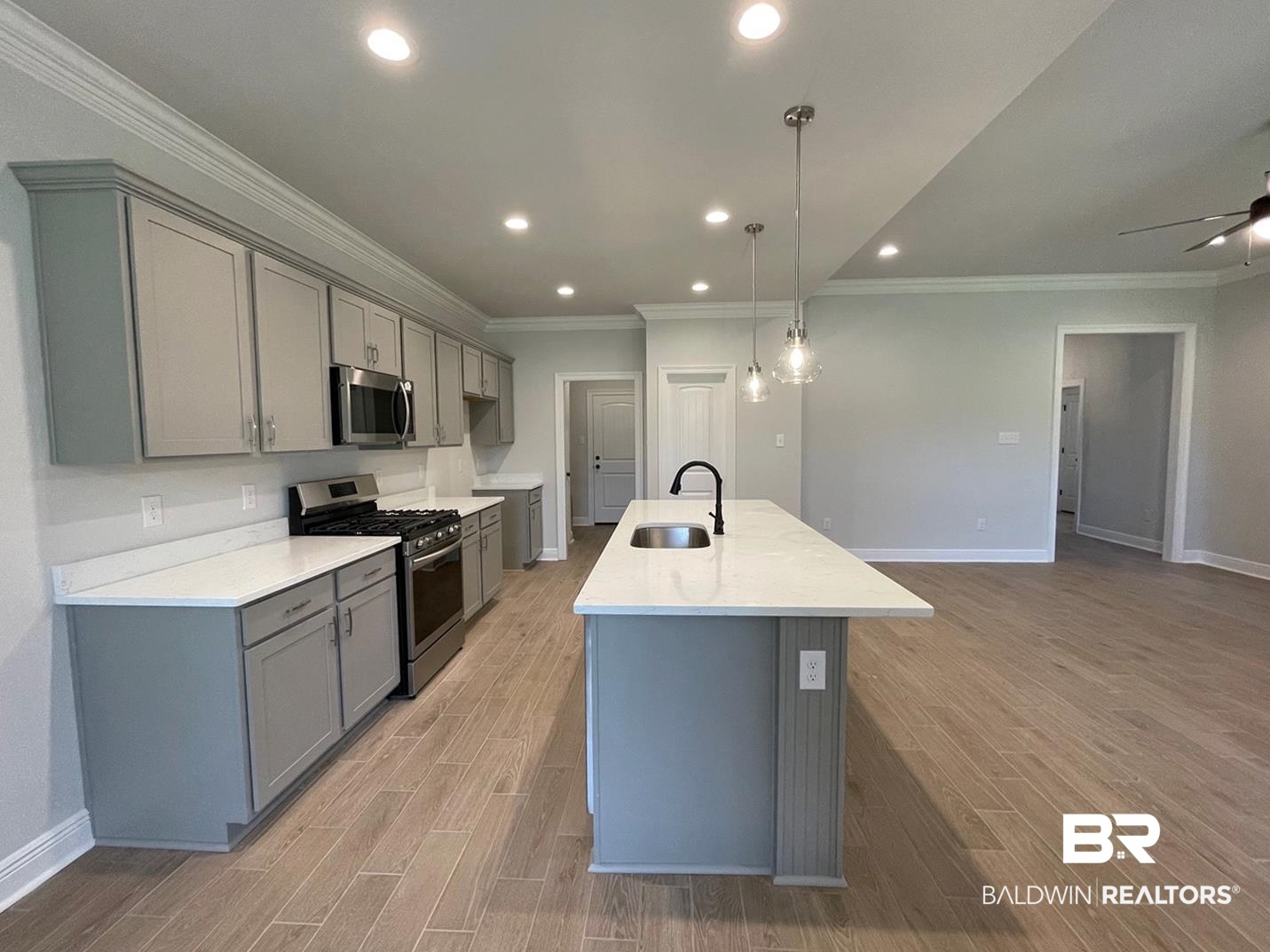 1630 Fenton Circle Foley, AL 36535 - Photo 4 of 14 Kitchen featuring stainless steel appliances, a center island with sink, gray cabinetry, light wood-type flooring, and ceiling fan
