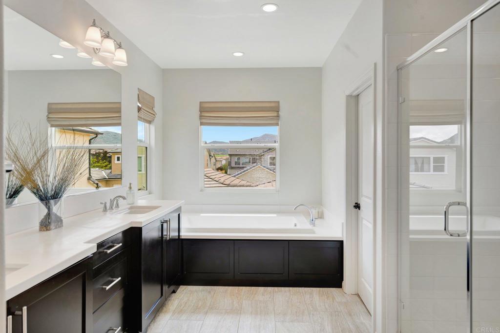 2954 Fledgling Drive Escondido, CA 92029 - Photo 24 of 49 a bathroom with a bathtub a sink and mirror