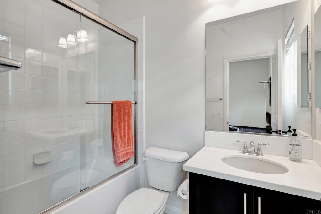 2954 Fledgling Drive Escondido, CA 92029 - Photo 26 of 49 a bathroom with a sink toilet vanity and shower