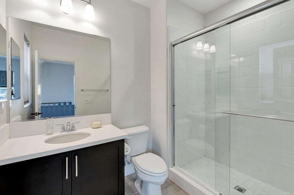 2954 Fledgling Drive Escondido, CA 92029 - Photo 27 of 49 a bathroom with a sink toilet and shower