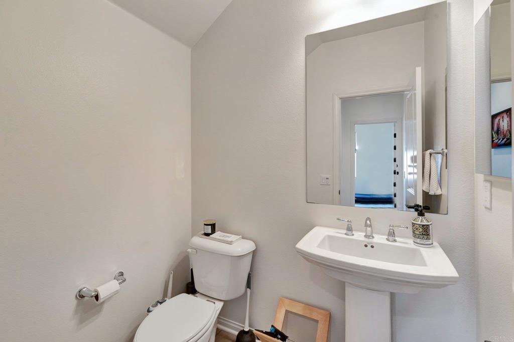 2954 Fledgling Drive Escondido, CA 92029 - Photo 28 of 49 a bathroom with a sink mirror and toilet