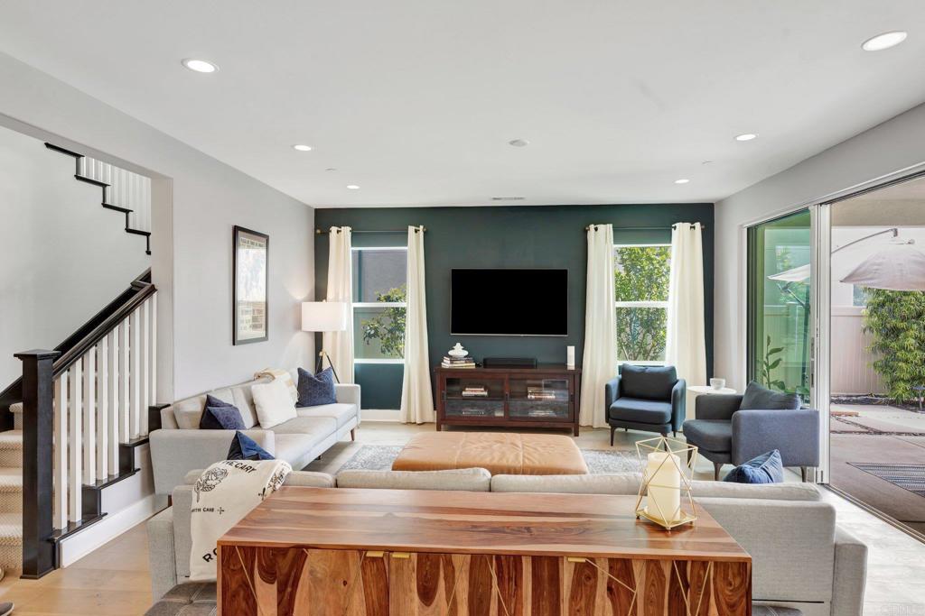 2954 Fledgling Drive Escondido, CA 92029 - Photo 6 of 49 a living room with furniture a flat screen tv and a large window