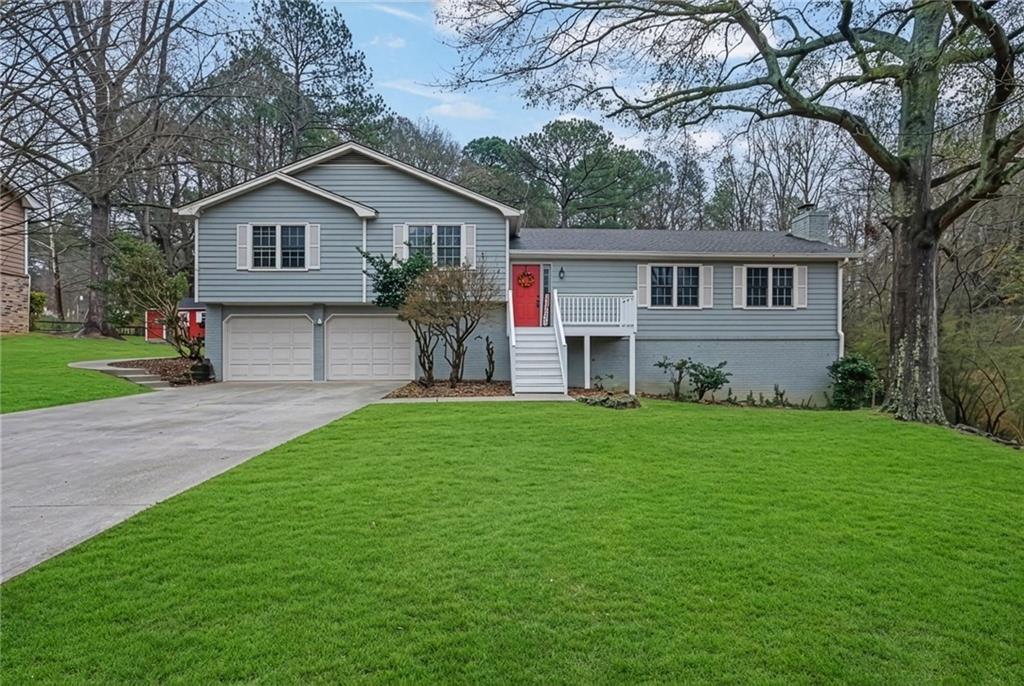a front view of house with yard and green space