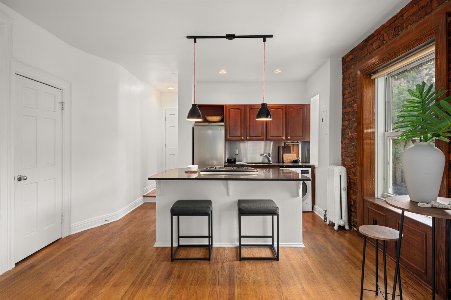 25 Charles Street, Unit 3D Manhattan, NY 10014 - Photo 12 of 13 a kitchen with a sink cabinets and wooden floor