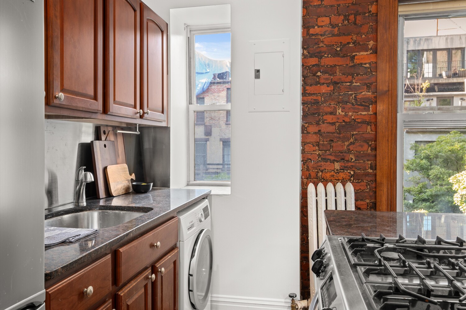 25 Charles Street, Unit 3D Manhattan, NY 10014 - Photo 2 of 13 a kitchen with stainless steel appliances granite countertop a sink stove and cabinets