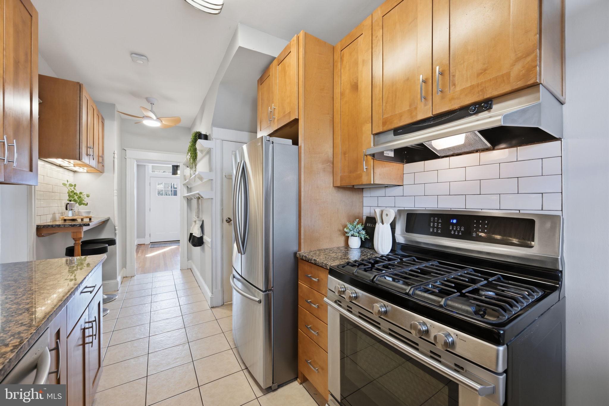443 Kenyon Street Northwest Washington, DC 20010 - Photo 12 of 30 a kitchen with stainless steel appliances granite countertop a stove a refrigerator and a sink