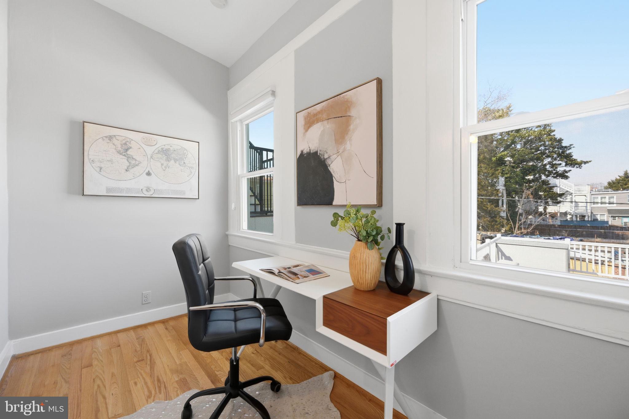 443 Kenyon Street Northwest Washington, DC 20010 - Photo 16 of 30 a view of a workspace with furniture and a window