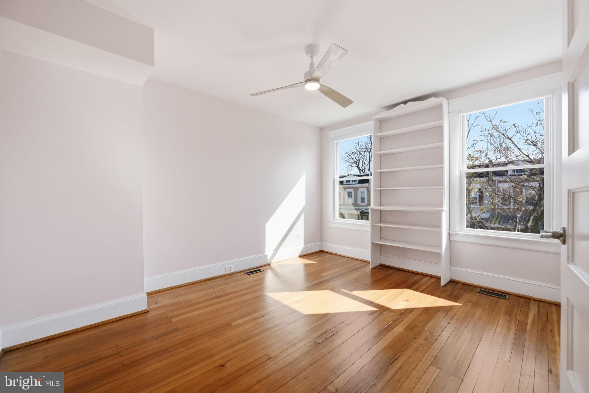 443 Kenyon Street Northwest Washington, DC 20010 - Photo 19 of 30 wooden floor in an empty room with a window