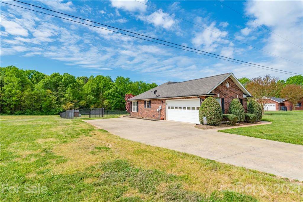 1508 Tom Helms Road Monroe, NC 28110 - Photo 3 of 23 a house with trees in front of it