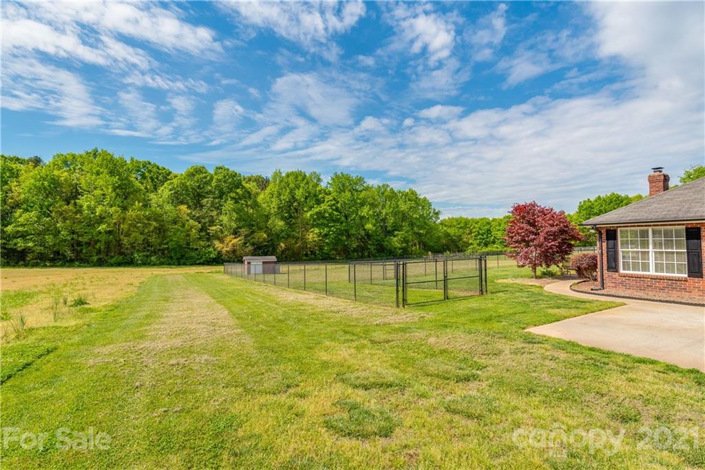1508 Tom Helms Road Monroe, NC 28110 - Photo 22 of 23 a swimming pool with trees in the background