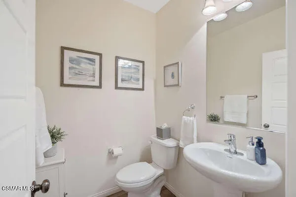 a bathroom with a toilet a sink and a mirror