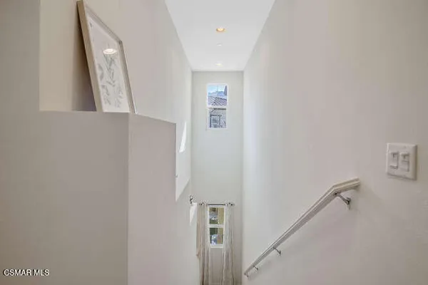 a view of a hallway with windows